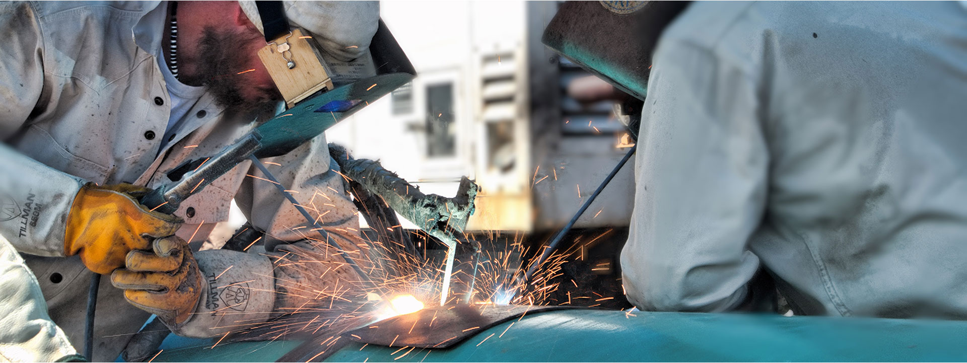 two-men-welding-pipe